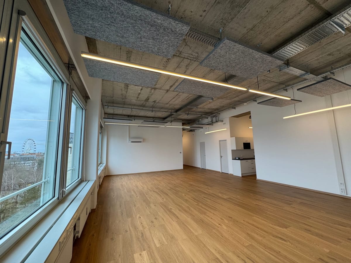 Fertige Bürofläche mit Fensterfront, Akustikelementen und Lichtlinien